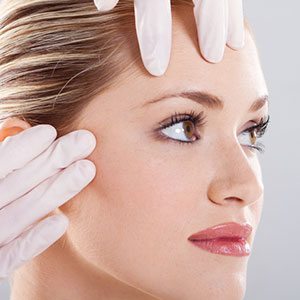 A woman who is recovering from a facelift procedure